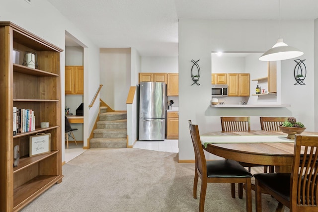 12977 Echo Ln, Apple Valley, MN 55124 - dining area featuring light carpet and stairs