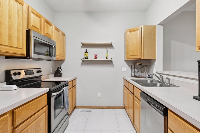 12977 Echo Ln, Apple Valley, MN 55124 - kitchen featuring appliances with stainless steel finishes, a sink, light countertops, and light tile patterned floors