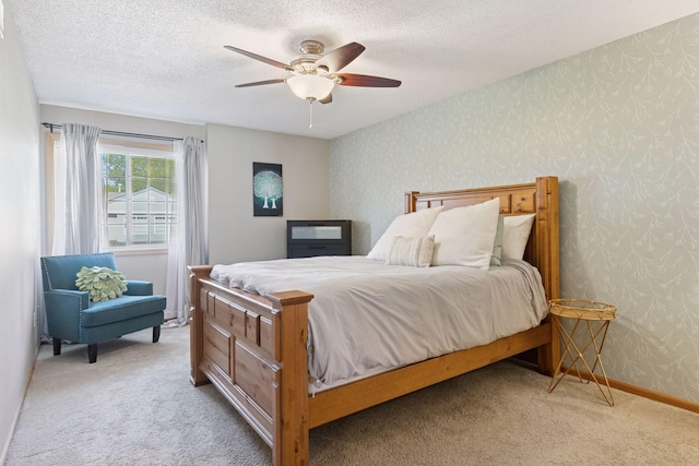 12977 Echo Ln, Apple Valley, MN 55124 - bedroom with wallpapered walls, light carpet, ceiling fan, a textured ceiling, and baseboards