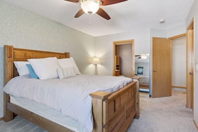 12977 Echo Ln, Apple Valley, MN 55124 - bedroom featuring light colored carpet, wallpapered walls, ceiling fan, and a textured ceiling