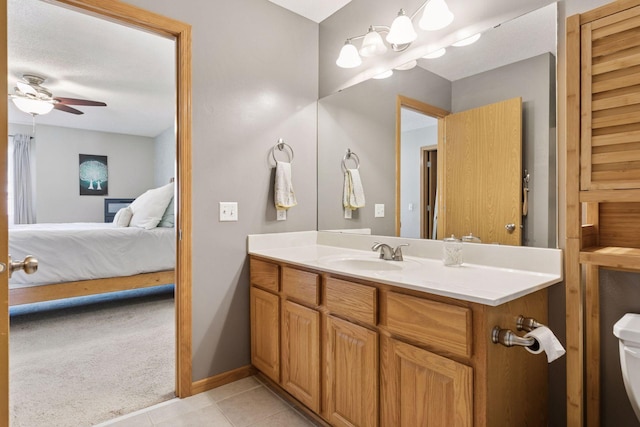 12977 Echo Ln, Apple Valley, MN 55124 - bathroom featuring ensuite bathroom, vanity, tile patterned flooring, a ceiling fan, and baseboards