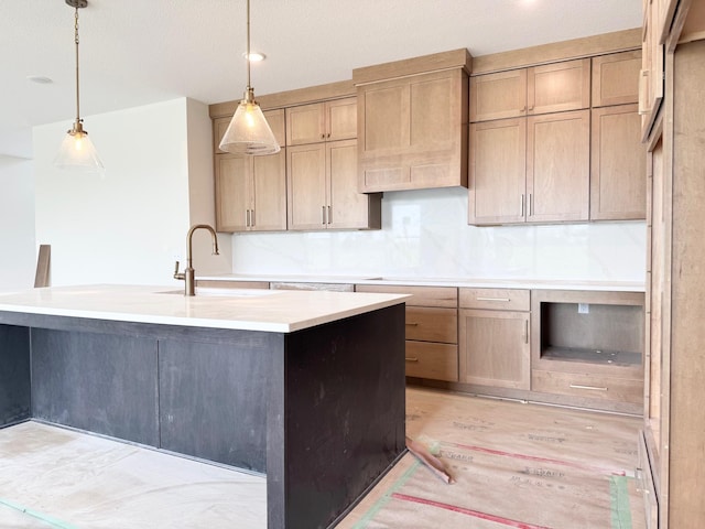 17970 103rd Ave N, Maple Grove, MN 55311 - kitchen featuring pendant lighting, light countertops, a center island with sink, and backsplash
