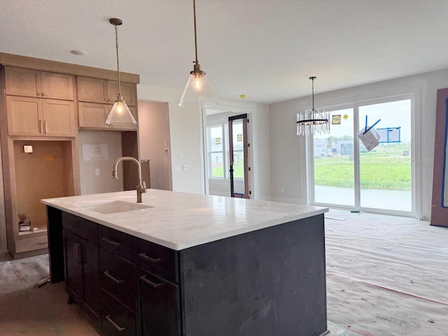 17970 103rd Ave N, Maple Grove, MN 55311 - kitchen featuring an island with sink, pendant lighting, light stone countertops, light wood-style floors, and a chandelier
