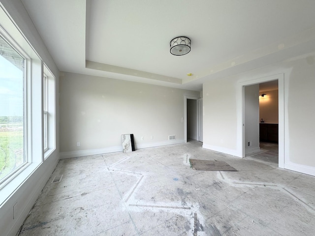 17970 103rd Ave N, Maple Grove, MN 55311 - unfurnished bedroom with multiple windows, a raised ceiling, and connected bathroom