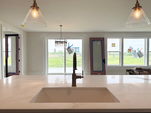 17970 103rd Ave N, Maple Grove, MN 55311 - kitchen with light stone countertops, pendant lighting, and a chandelier