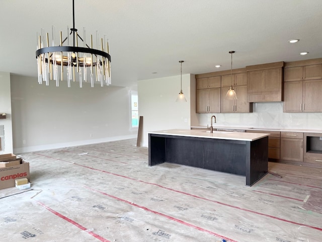 17970 103rd Ave N, Maple Grove, MN 55311 - kitchen with open floor plan, a kitchen island with sink, light countertops, decorative backsplash, and decorative light fixtures