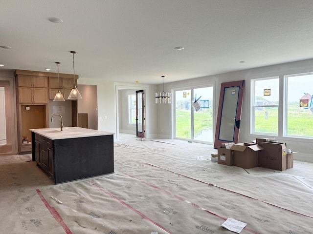 17970 103rd Ave N, Maple Grove, MN 55311 - kitchen featuring a kitchen island with sink, hanging light fixtures, light countertops, and open floor plan