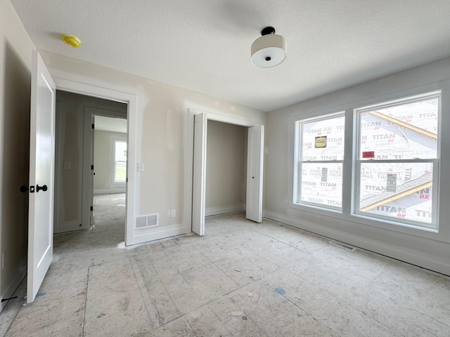 17970 103rd Ave N, Maple Grove, MN 55311 - unfurnished bedroom featuring a textured ceiling and a closet