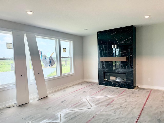 17970 103rd Ave N, Maple Grove, MN 55311 - unfurnished living room featuring recessed lighting and a premium fireplace