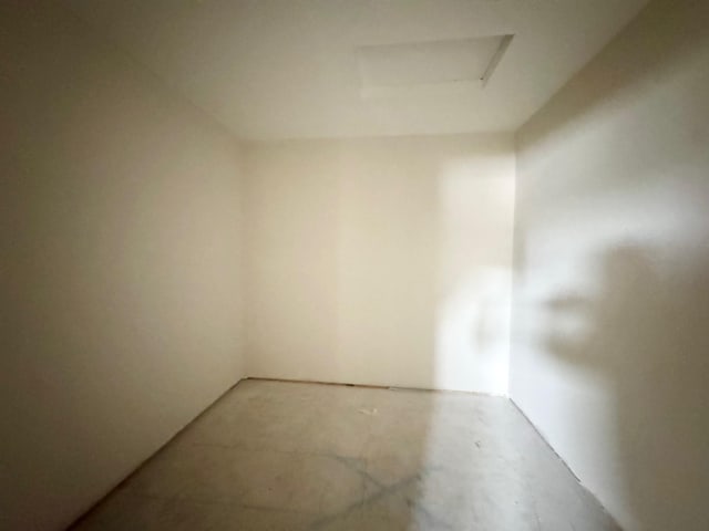 17970 103rd Ave N, Maple Grove, MN 55311 - spare room featuring unfinished concrete floors and attic access