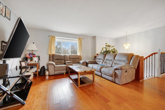 living room with a chandelier and light wood-type flooring
