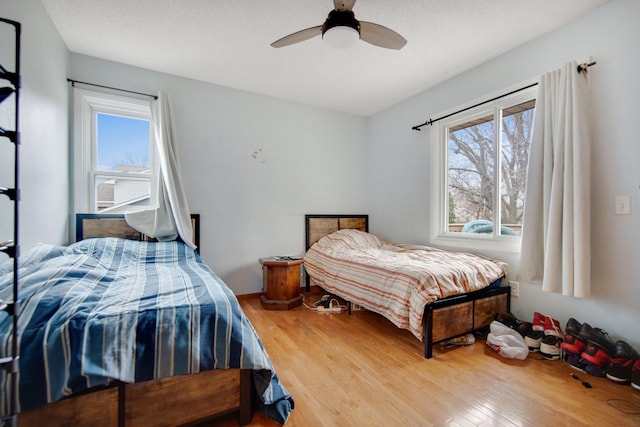bedroom featuring wood finished floors and a ceiling fan