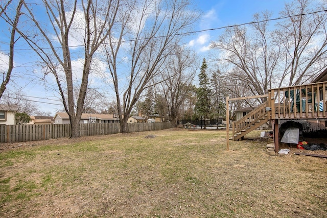 view of yard featuring a deck and stairway