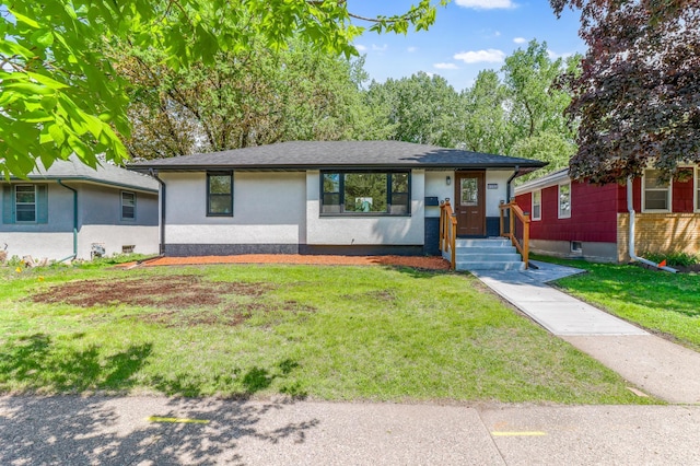 view of front of house with a front yard and stucco siding