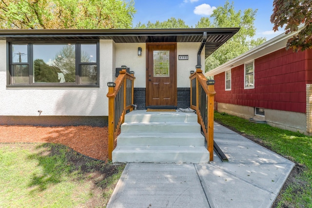 entrance to property featuring stucco siding