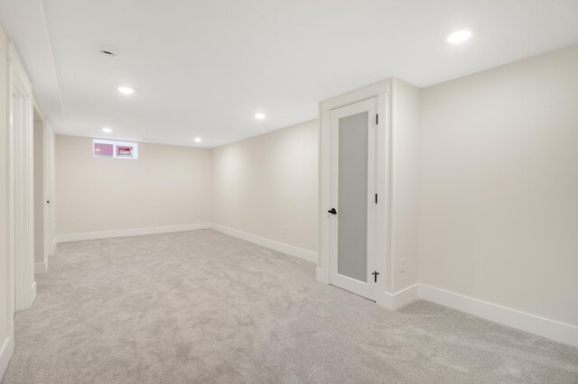 below grade area with light colored carpet, recessed lighting, and baseboards