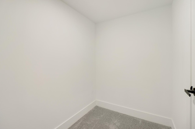unfurnished room with carpet floors and baseboards