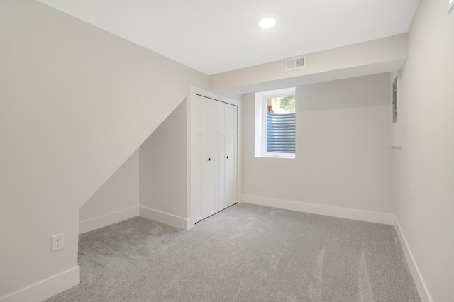 unfurnished bedroom with carpet, baseboards, a closet, and recessed lighting