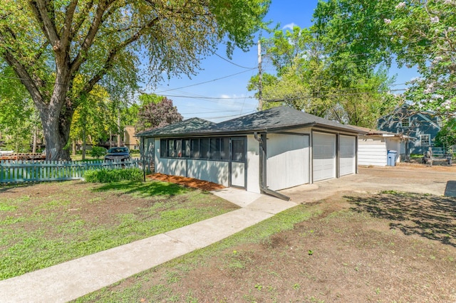 detached garage featuring fence