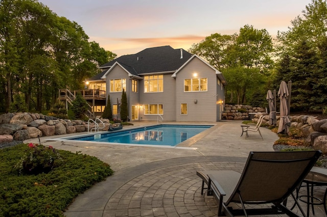 14575 268th Ave NW, Zimmerman, MN 55398 - pool at dusk featuring stairway, a patio area, a deck, and an outdoor pool