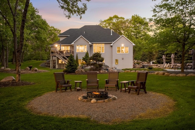 14575 268th Ave NW, Zimmerman, MN 55398 - rear view of house featuring an outdoor fire pit, stairs, a lawn, and a wooden deck