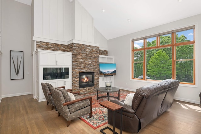 14575 268th Ave NW, Zimmerman, MN 55398 - living room with wood finished floors, baseboards, high vaulted ceiling, and a fireplace