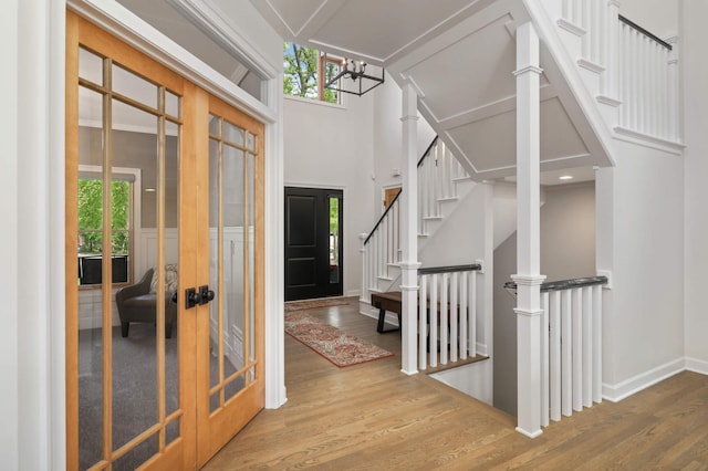 14575 268th Ave NW, Zimmerman, MN 55398 - foyer entrance with wood finished floors, a chandelier, stairs, a towering ceiling, and french doors