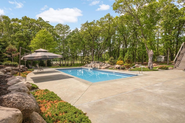 14575 268th Ave NW, Zimmerman, MN 55398 - view of swimming pool featuring stairway, a patio, a gazebo, and view of wooded area
