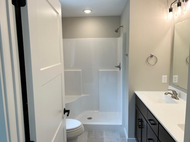 full bath featuring toilet, a shower, double vanity, and tile patterned flooring