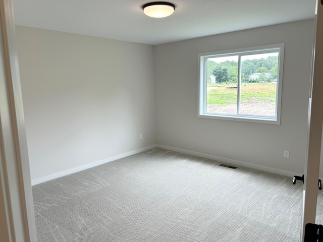 unfurnished room with carpet flooring and baseboards