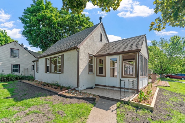 2216 57th St, Minneapolis, MN 55419 - view of front of home featuring a sunroom, roof with shingles, and stucco siding