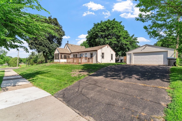 2216 57th St, Minneapolis, MN 55419 - view of front of house featuring a garage, a front yard, an outbuilding, and a deck