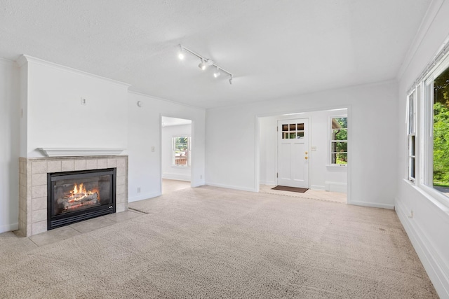 2216 57th St, Minneapolis, MN 55419 - unfurnished living room with carpet flooring, a tile fireplace, healthy amount of natural light, rail lighting, and crown molding