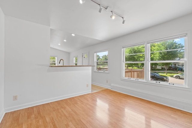 2216 57th St, Minneapolis, MN 55419 - empty room with rail lighting, plenty of natural light, light wood-type flooring, lofted ceiling, and recessed lighting