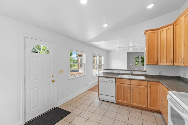 2216 57th St, Minneapolis, MN 55419 - kitchen featuring white appliances, dark countertops, light tile patterned floors, rail lighting, and a peninsula