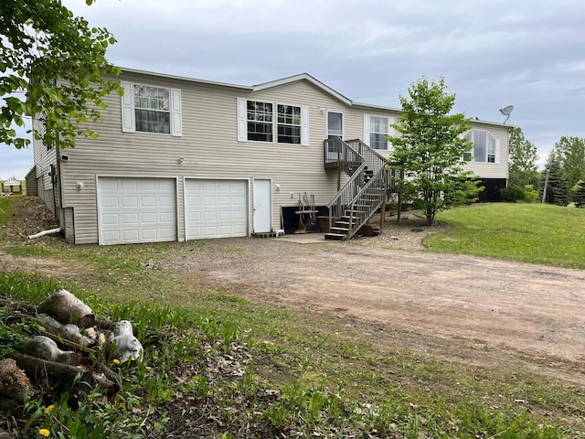 1141 Mahogany St, Mora, MN 55051 - view of front facade featuring driveway, an attached garage, and stairs