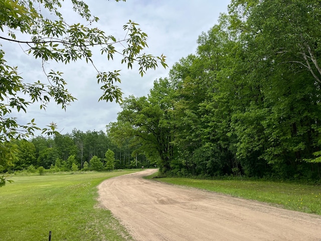1141 Mahogany St, Mora, MN 55051 - view of dirt / gravel road featuring a wooded view