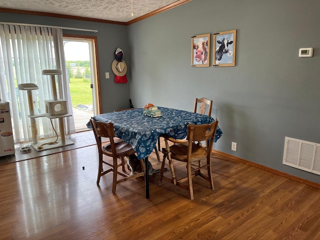 1141 Mahogany St, Mora, MN 55051 - dining area featuring ornamental molding, wood finished floors, and baseboards