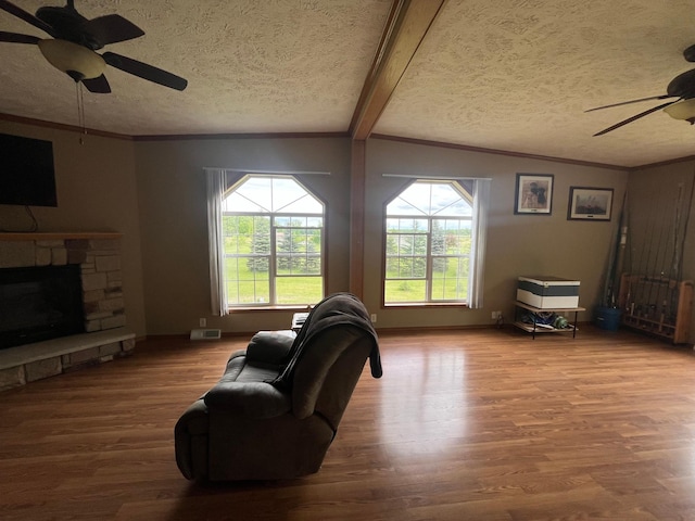 1141 Mahogany St, Mora, MN 55051 - living area featuring ceiling fan, healthy amount of natural light, wood finished floors, crown molding, and a textured ceiling