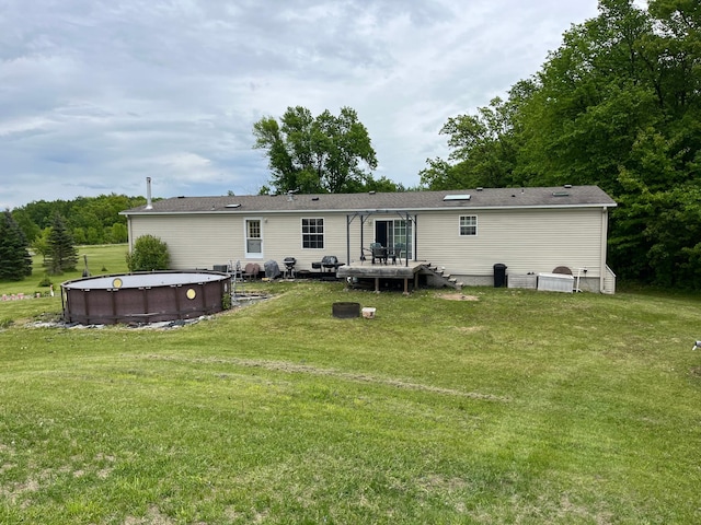 1141 Mahogany St, Mora, MN 55051 - rear view of property featuring a lawn and an outdoor pool