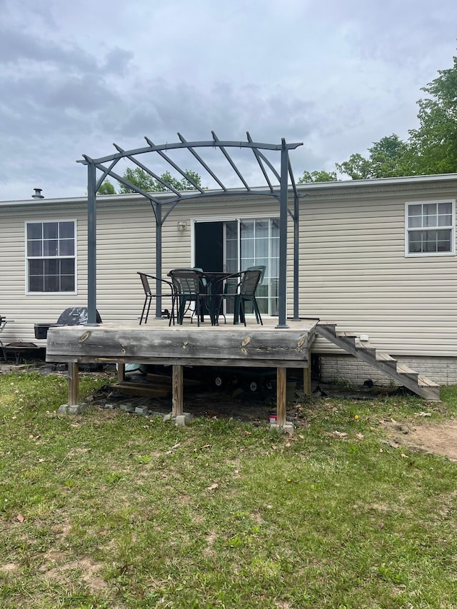 1141 Mahogany St, Mora, MN 55051 - rear view of house featuring a wooden deck and a yard