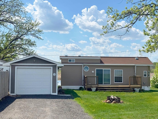 7625 US Highway 169, Garrison, MN 56450 - view of front facade with an outdoor fire pit, a deck, driveway, a front yard, and an outdoor structure