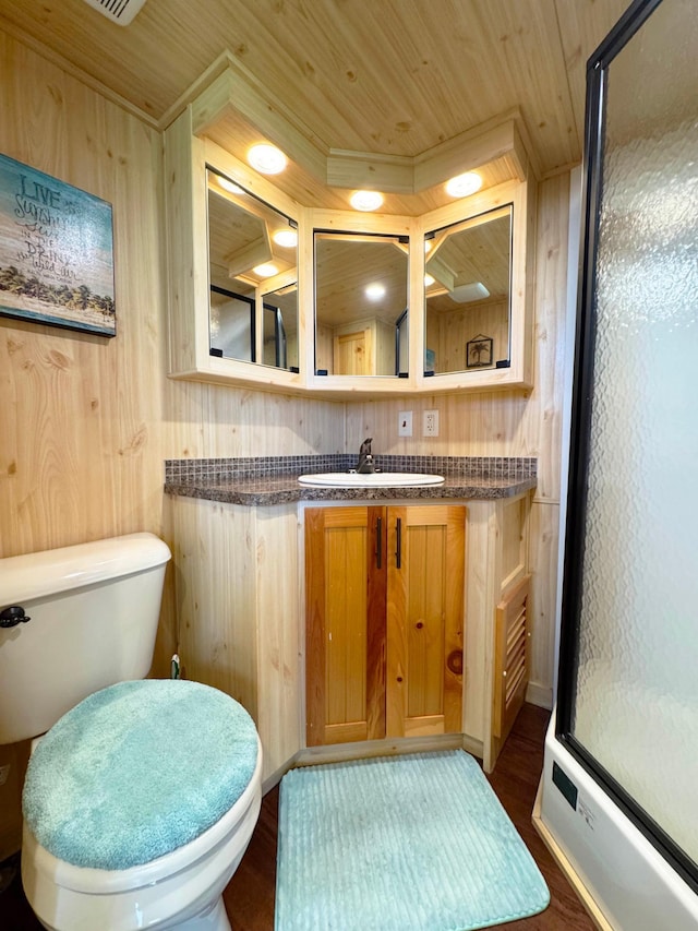 7625 US Highway 169, Garrison, MN 56450 - full bath with a shower with door, toilet, wood walls, vanity, and wood finished floors