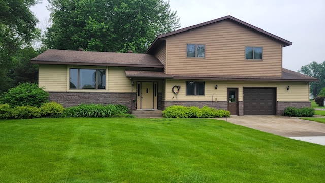 17473 Fairway Cir, Cold Spring, MN 56320 - tri-level home featuring a front lawn, concrete driveway, a garage, and stone siding