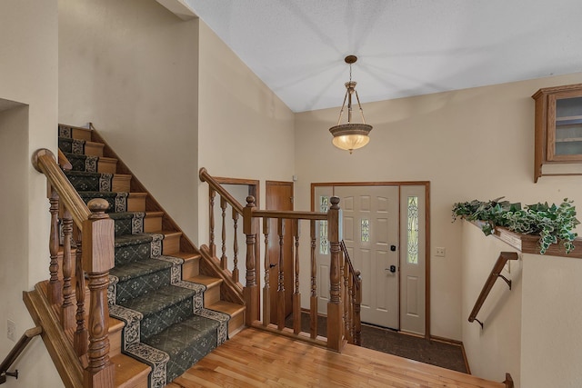 17473 Fairway Cir, Cold Spring, MN 56320 - entryway featuring wood finished floors, stairway, and a high ceiling