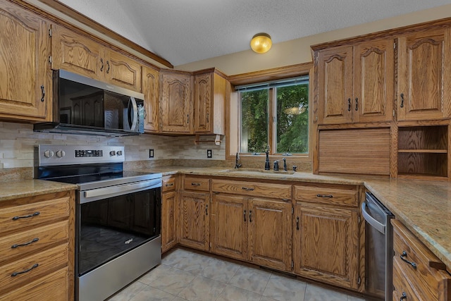17473 Fairway Cir, Cold Spring, MN 56320 - kitchen with stainless steel appliances, brown cabinets, tasteful backsplash, a textured ceiling, and light countertops