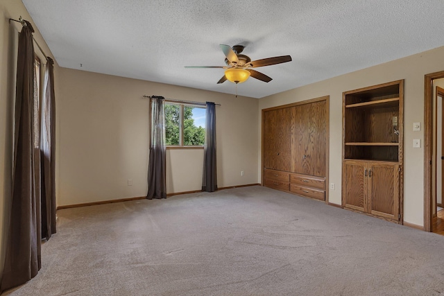 17473 Fairway Cir, Cold Spring, MN 56320 - unfurnished bedroom with a textured ceiling, light colored carpet, a ceiling fan, and multiple closets