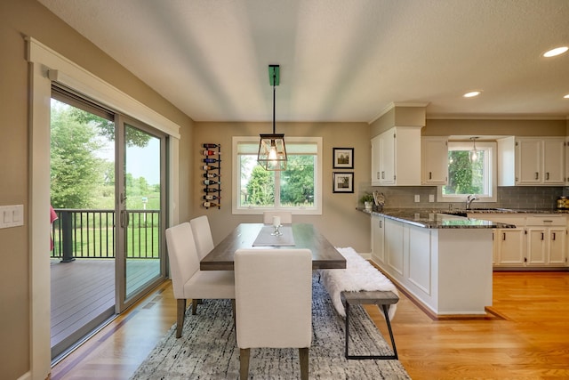 dining area with light wood-style flooring and recessed lighting
