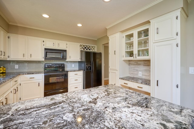 kitchen featuring black appliances, dark stone countertops, glass insert cabinets, decorative backsplash, and recessed lighting