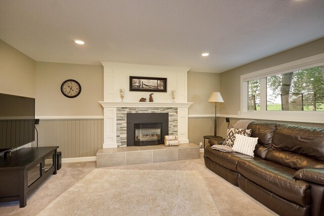 living area featuring wainscoting, carpet, a fireplace, and recessed lighting